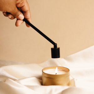 black candle snuffer in use