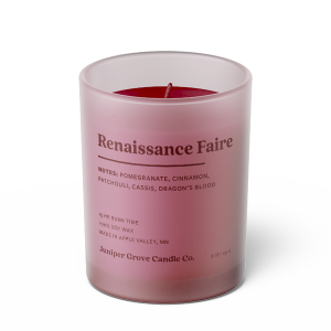 red renaissance faire scented candle in a glass jar