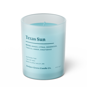 light blue texas sun scented candle in a medium glass jar