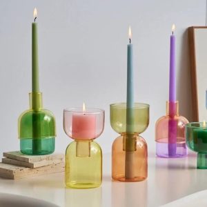 colored taper candles in multicolored glass holders